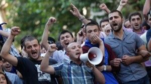 Men protest after a prisoner is raped with a broomstick