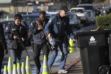 Police officers collect guns from people in their cars at a gun buyback held by the LAPD in Los Angeles